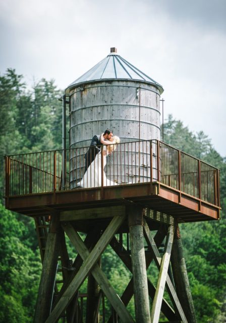 The couple kissing on the water tower. Smoky mountain wedding packages all inclusive - wedding venues in knoxville tn